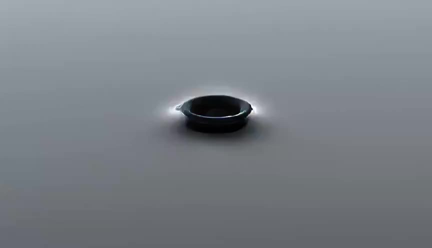 A drop of ink blooming and unfurling in still water, extreme macro.